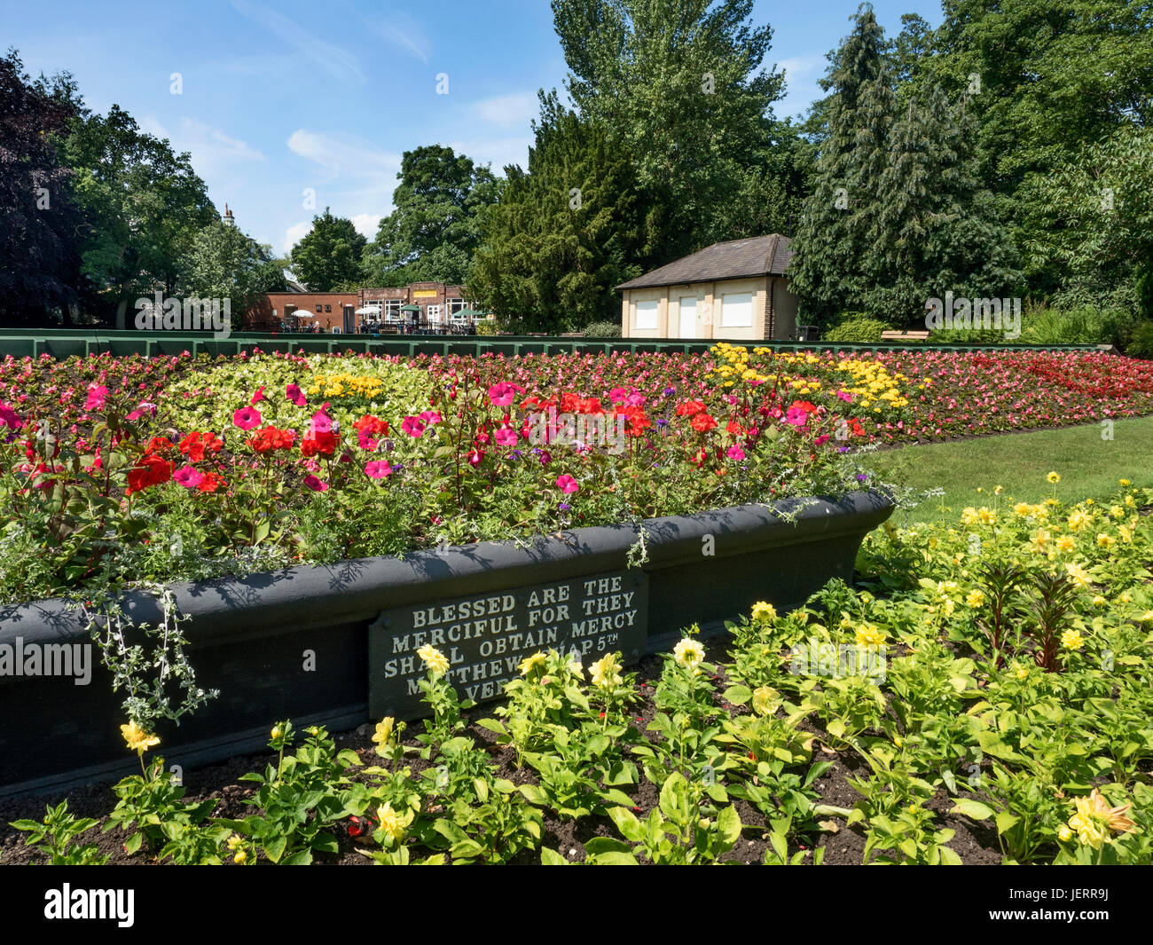 Summer Flowers and Planter with Biblical Quotation in Spa Gardens at Ripon North Yorkshire England Stock Photo