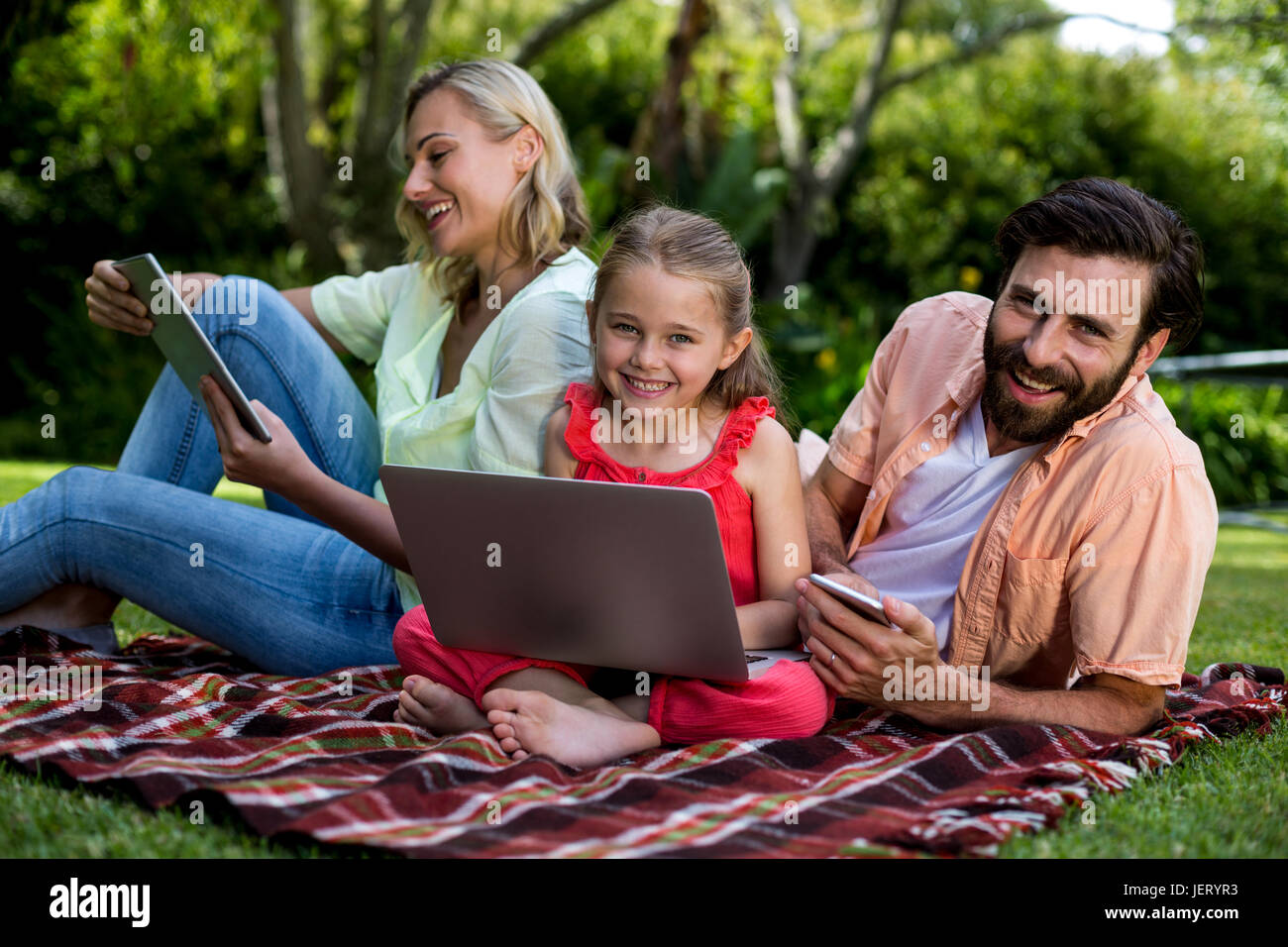 Family relaxing together in backyard hi-res stock photography and ...
