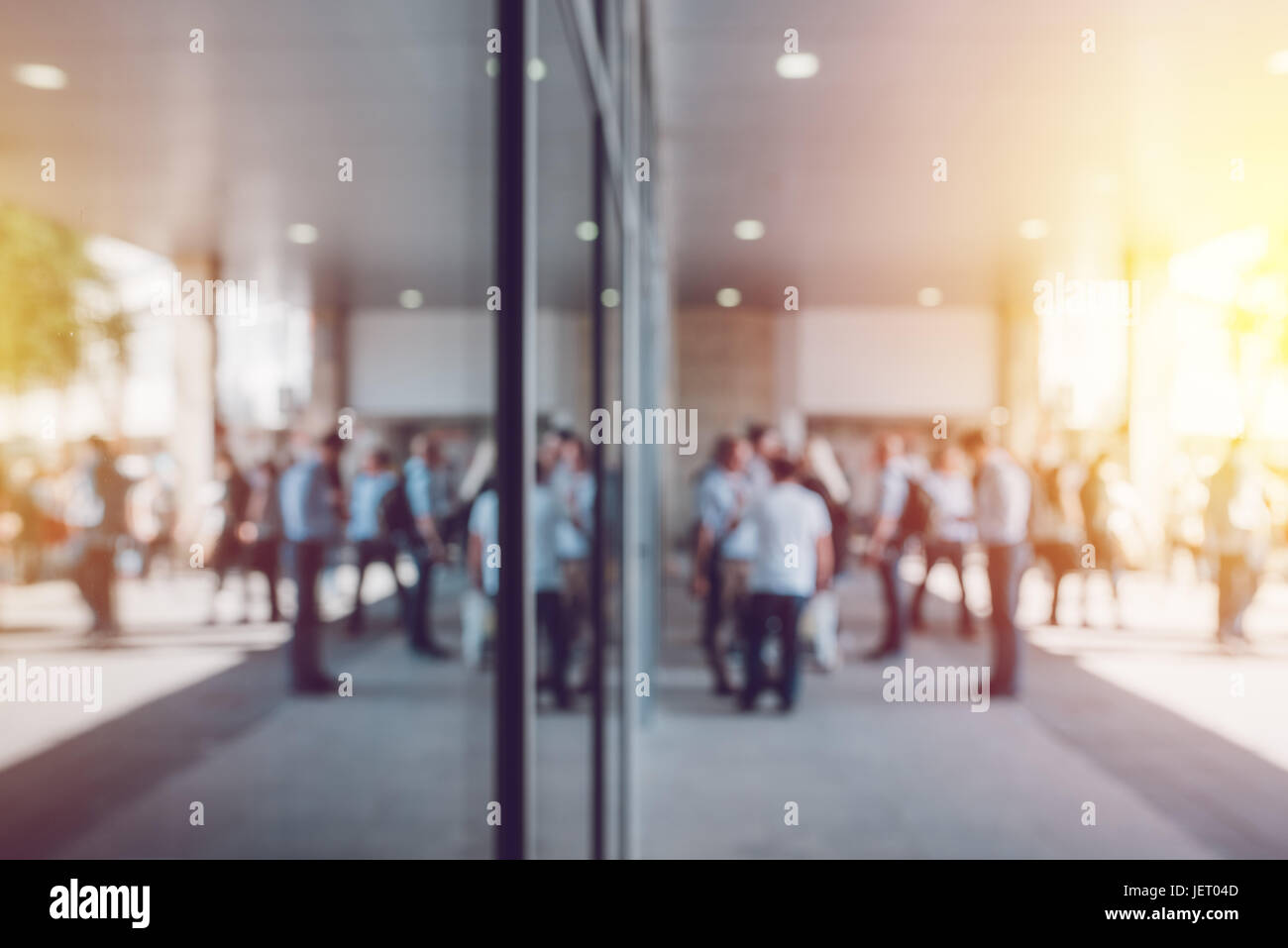 Abstract blur business and entrepreneurship background, unrecognizable crowd of businesspeople in front of corporate premises Stock Photo