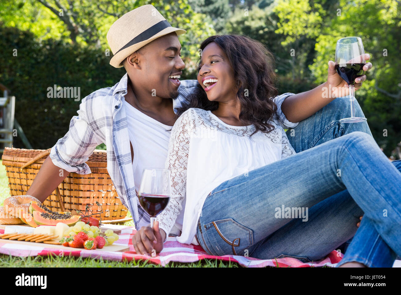 Young couple having a picnic in the park Stock Photo - Alamy