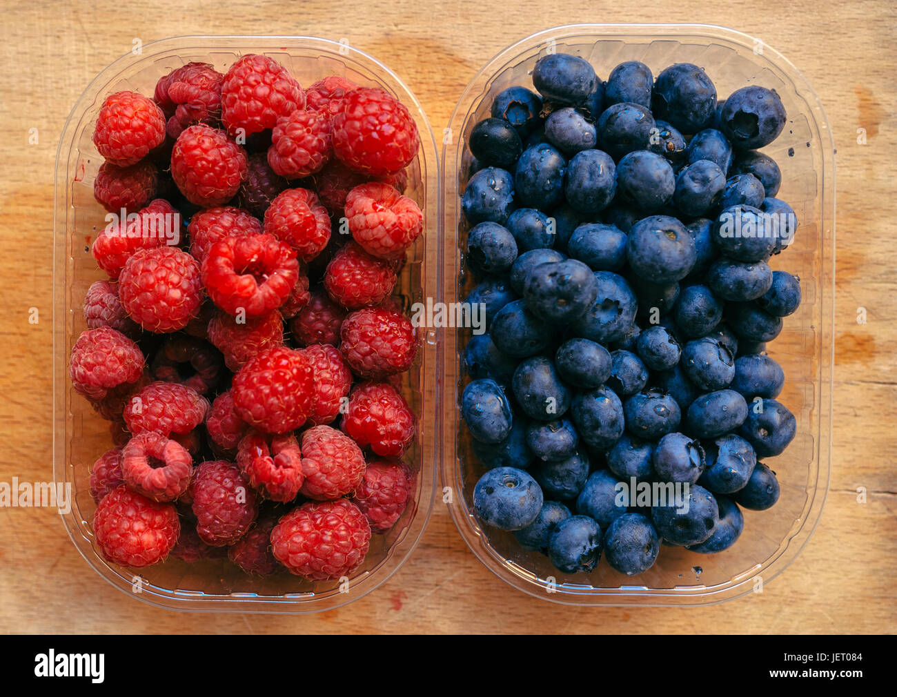Blueberries and raspberries, healthy forest berry fruit, top view Stock Photo