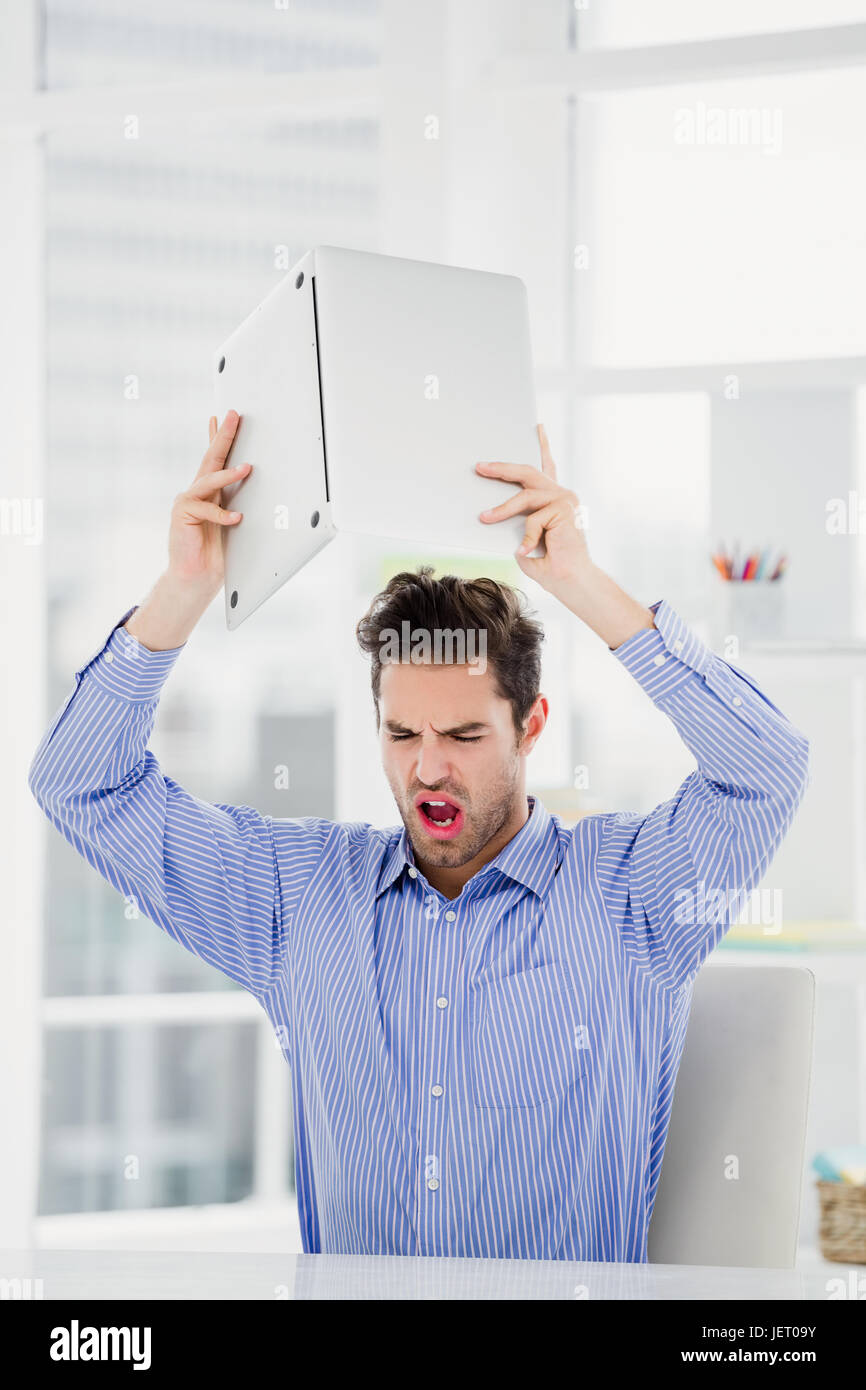 Frustrated businessman throwing laptop Stock Photo Alamy