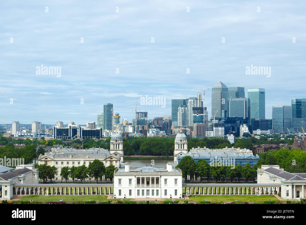 View of Royal chapel, Painted hall and classic colonnade in Greenwich park, London, and skyscrapers of Canary Wharf in the distance seen from the Gree Stock Photo