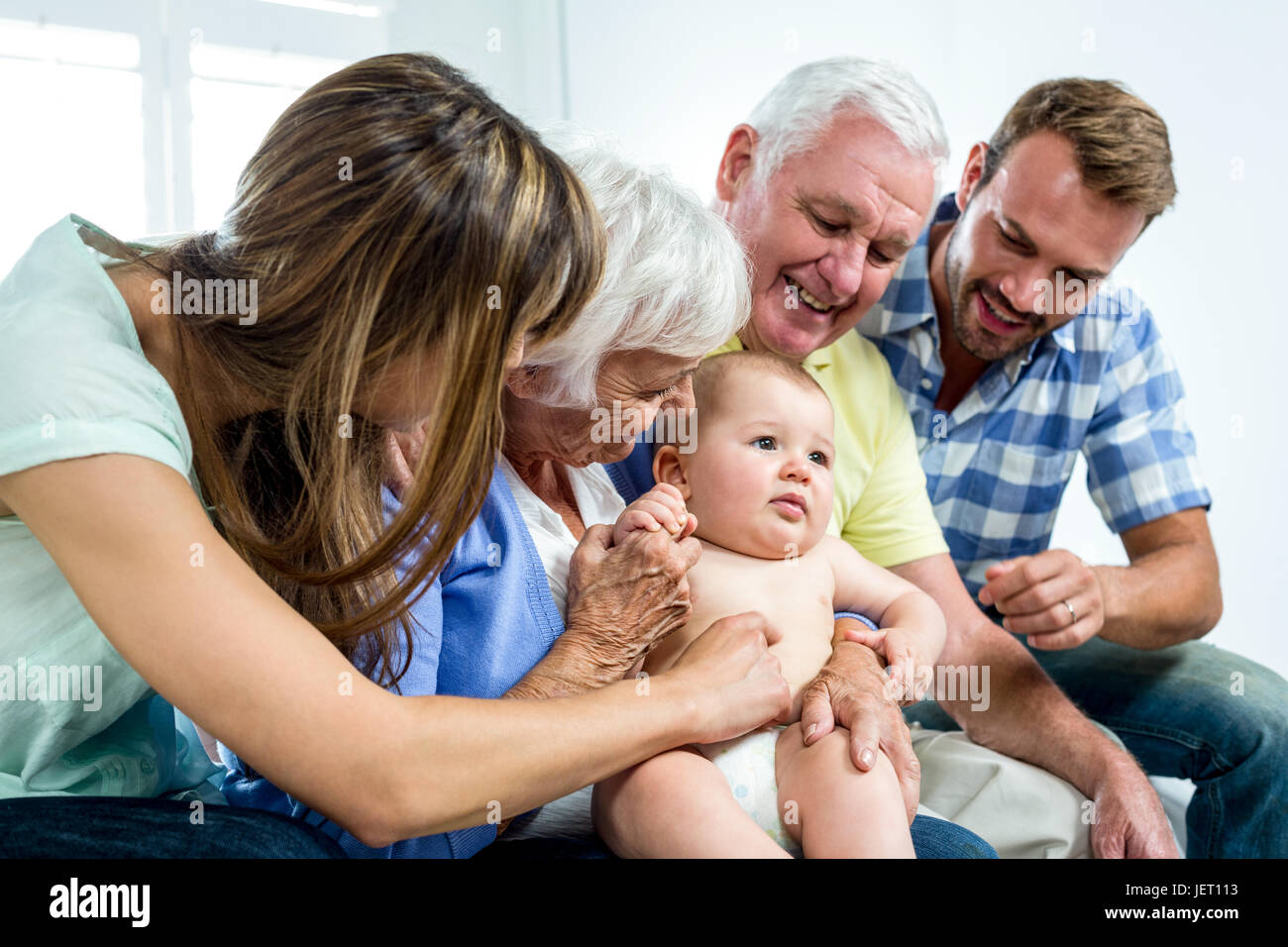 Family playing with cute baby boy at home Stock Photo