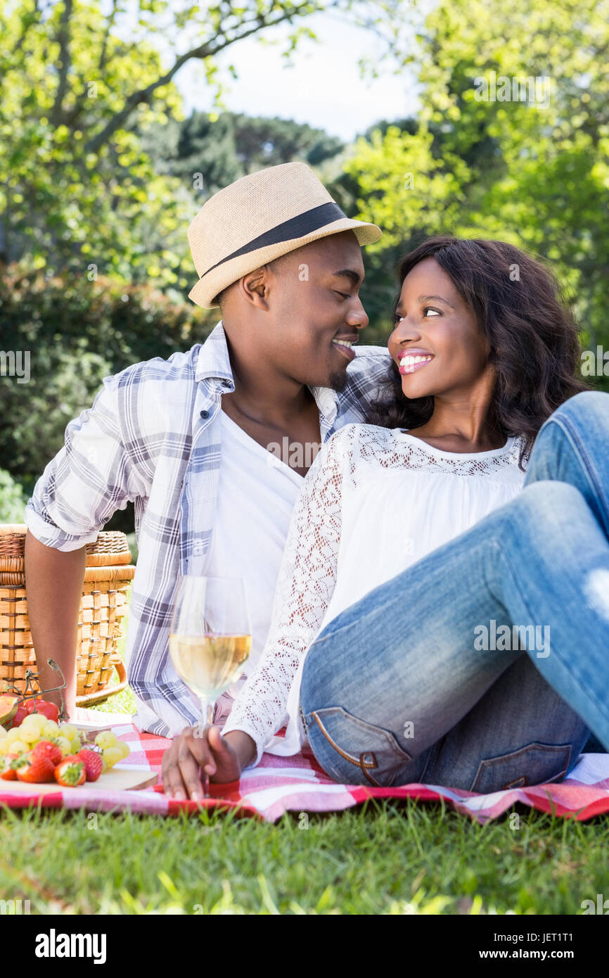 Young couple having a picnic in the park Stock Photo - Alamy