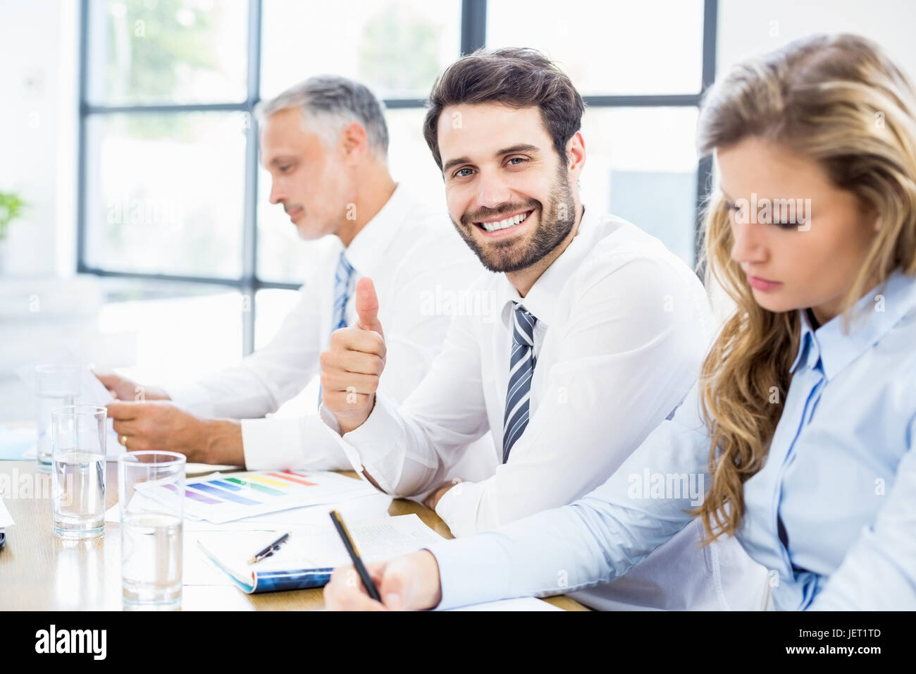 Portrait of businessman showing thumbs up Stock Photo - Alamy