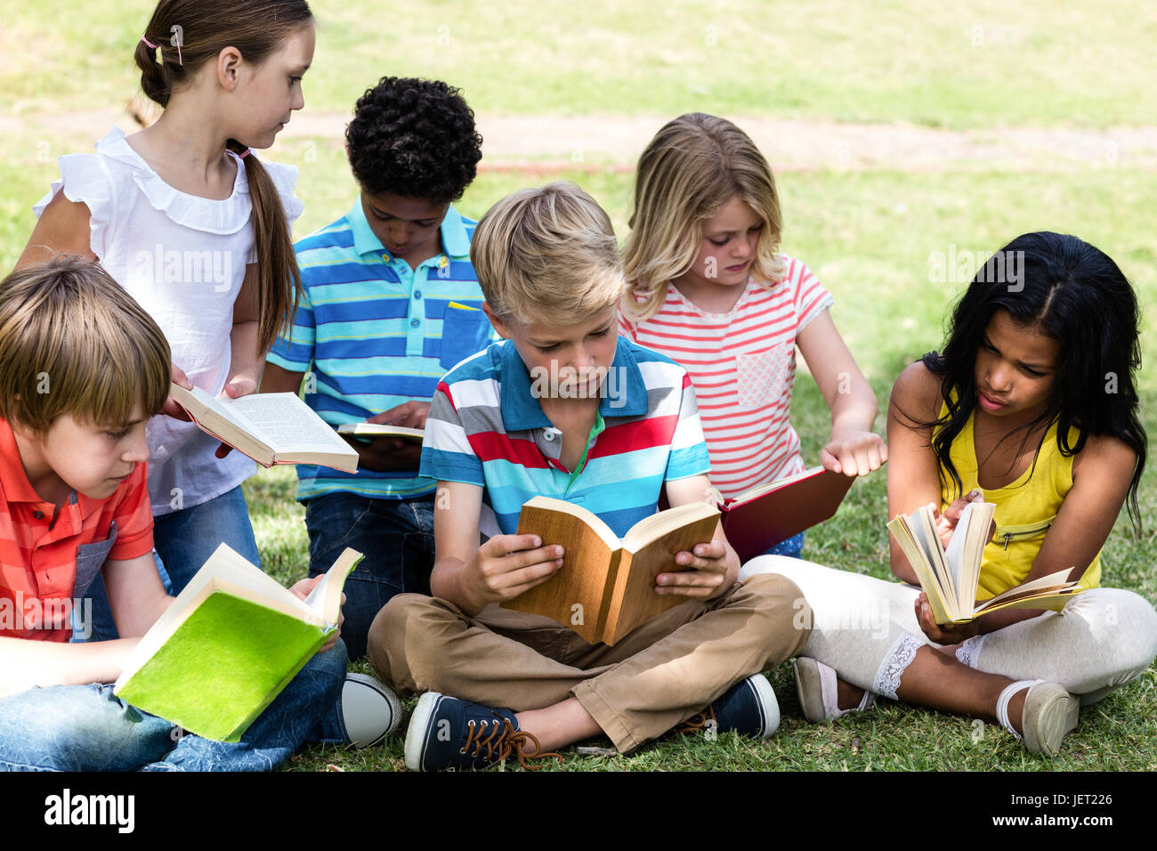 Children reading in park hi-res stock photography and images - Alamy