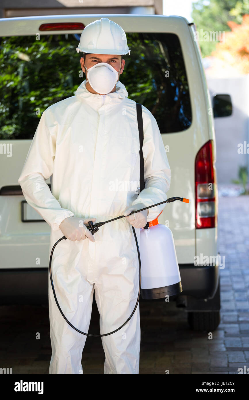 Pest control man standing behind a van Stock Photo Alamy