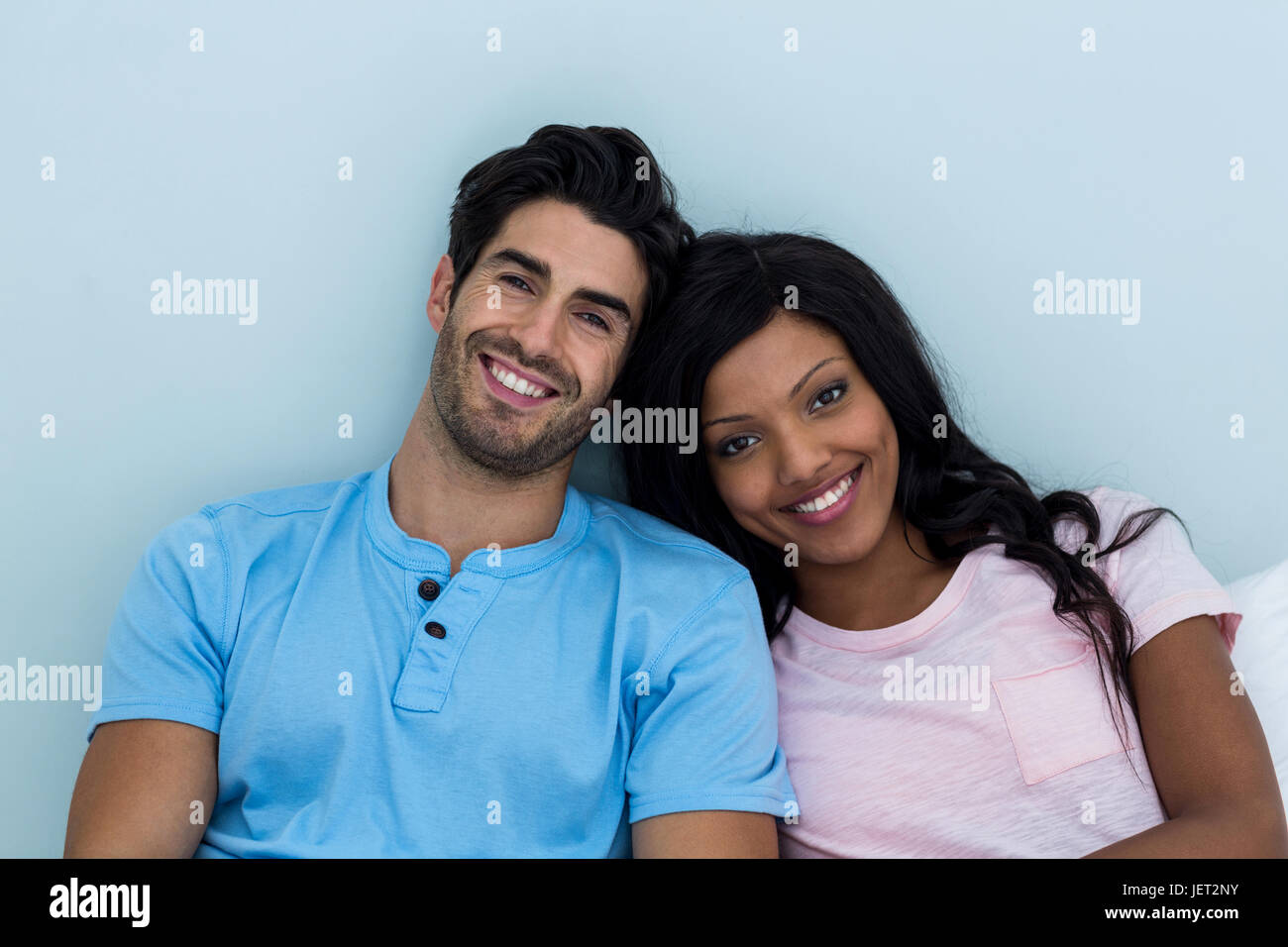 Young couple smiling at camera Stock Photo - Alamy