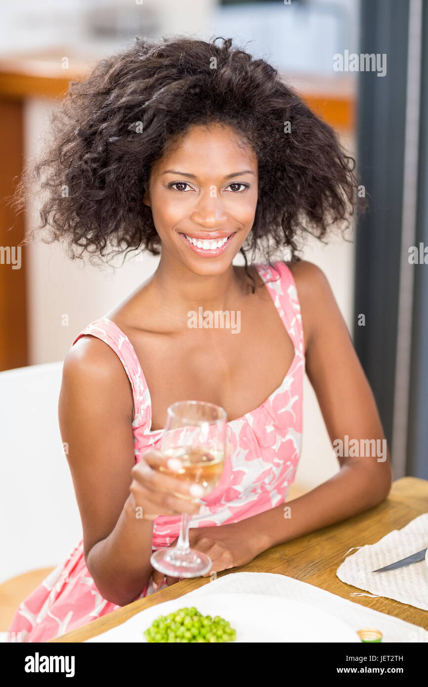 Young woman holding a glass of wine Stock Photo - Alamy