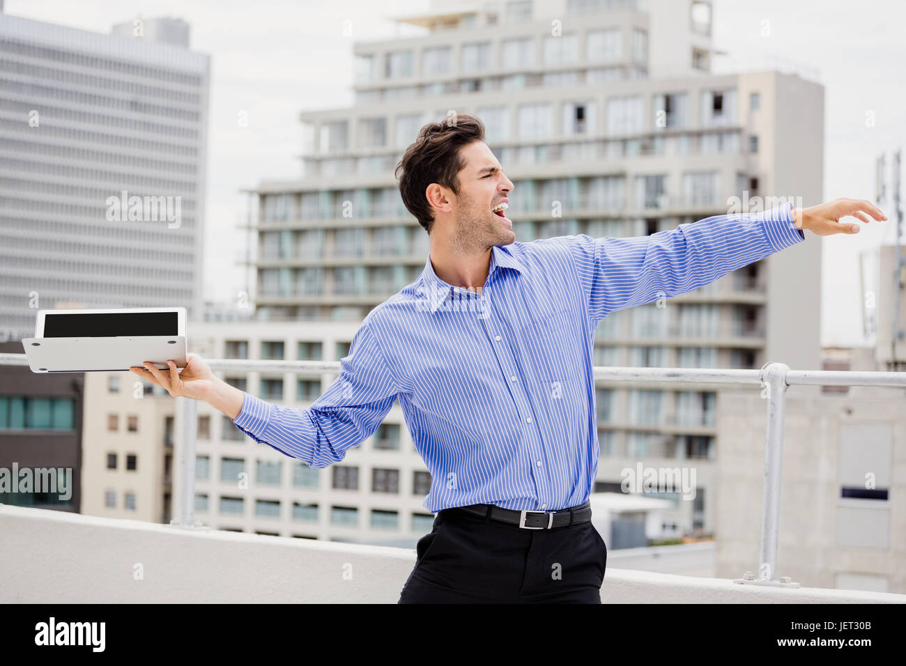 Frustrated businessman throwing laptop Stock Photo Alamy