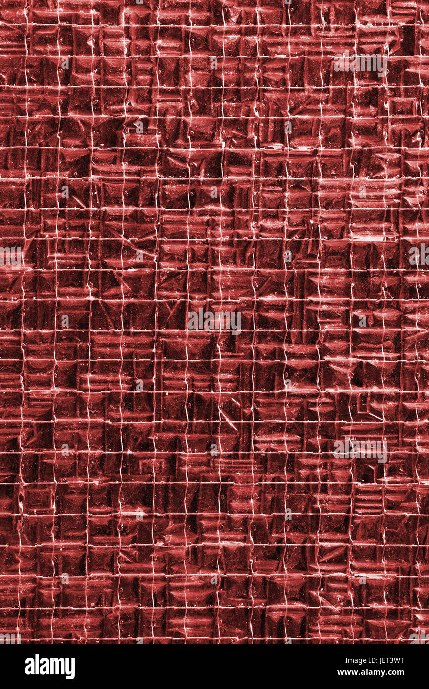 Background texture of red stained glass reinforced with metal wire mesh grid, close up Stock Photo