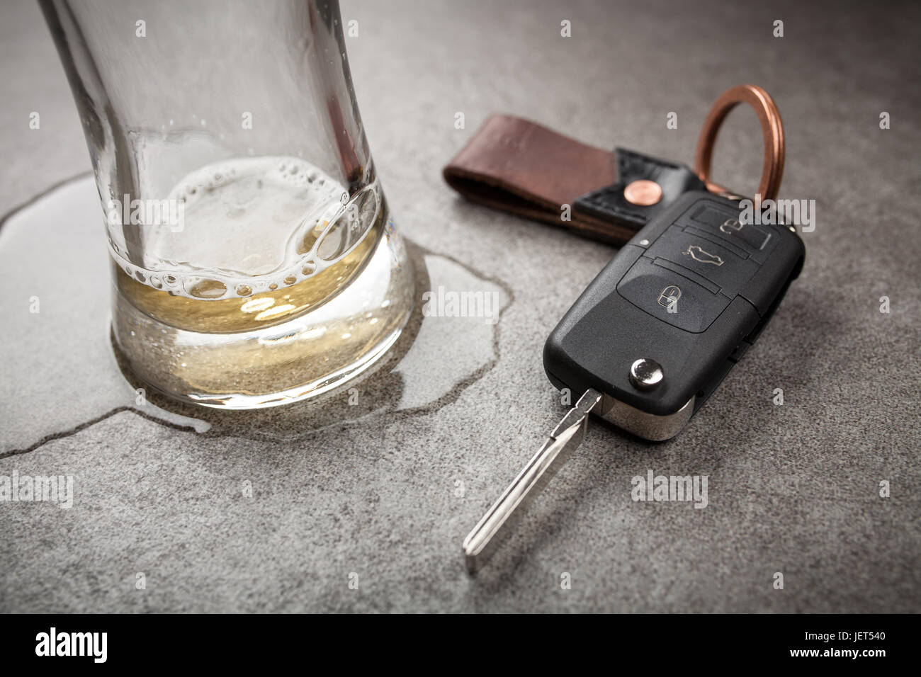 Drunk driving concept spilled beer and car keys on a table Stock
