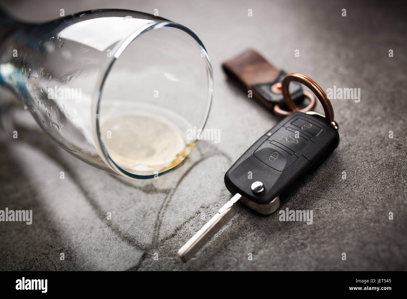 Drunk driving concept spilled beer and car keys on a table Stock