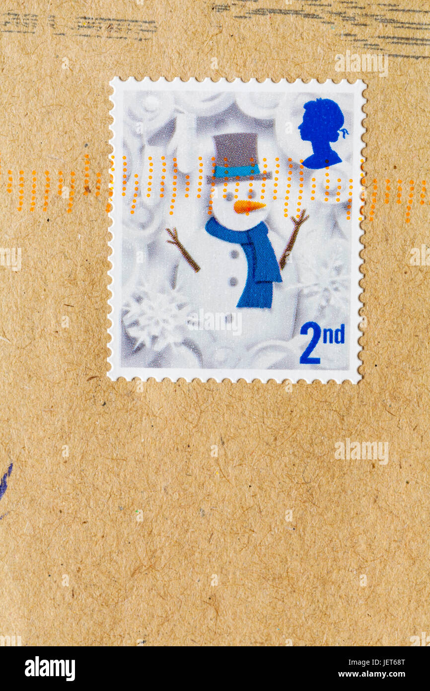 2nd class postage stamp with snowman stuck on brown envelope Stock