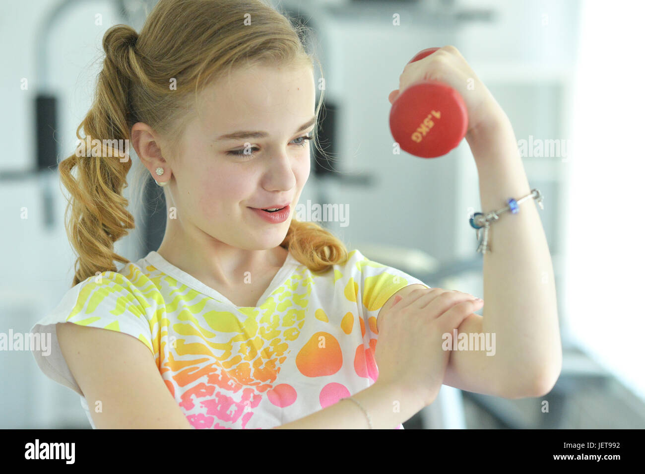 Cute little girl doing exercises with dumbbell Stock Photo - Alamy