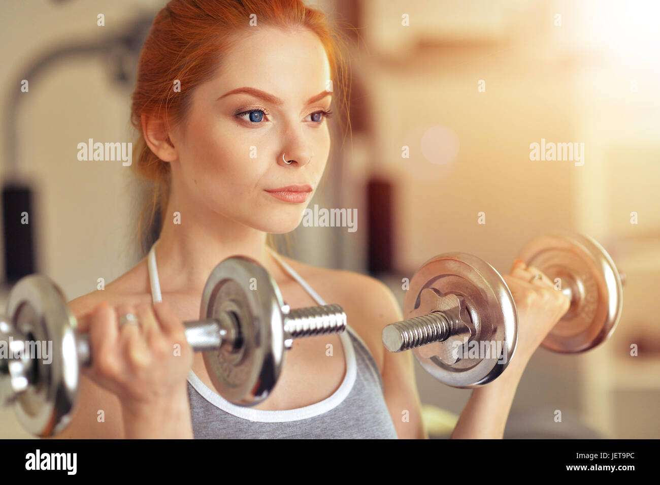 Portrait of a sporty young woman training in gym Stock Photo - Alamy