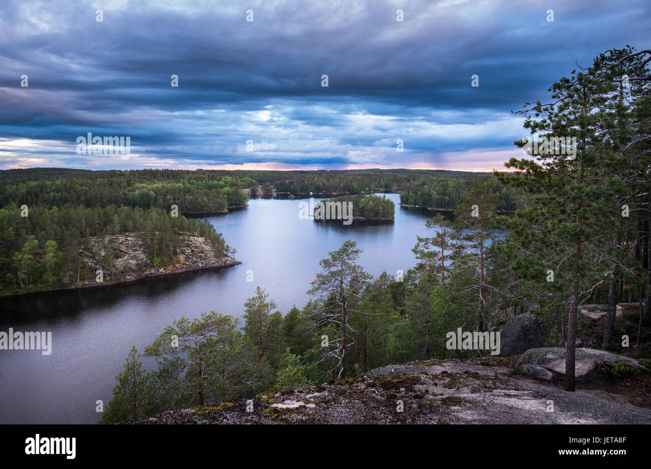 Scenic landscape with lake and storm clouds at summer evening in Repovesi, National Park. Finland Stock Photo
