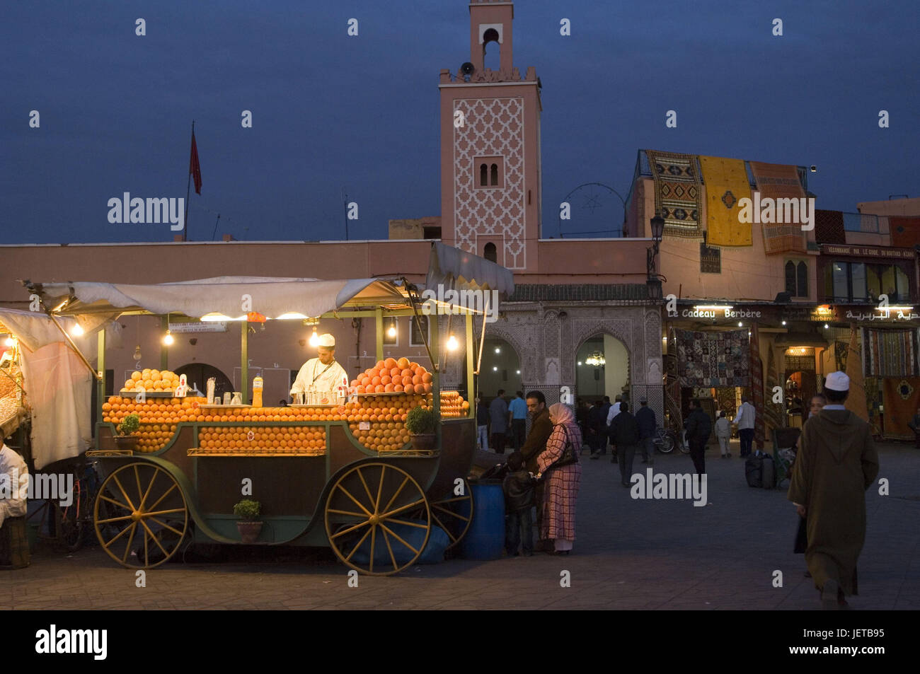 Morocco, Marrakech, Jemaa-El-Fna square, sales booth, Oozeable, oranges, people, dusk, Africa, North Africa, marketplace, market, street scene, pedestrian, passer-by, outside, dusk, beach, street sales, market stall, carriage, fruit juice, orange juice, fruits, many, Stock Photo