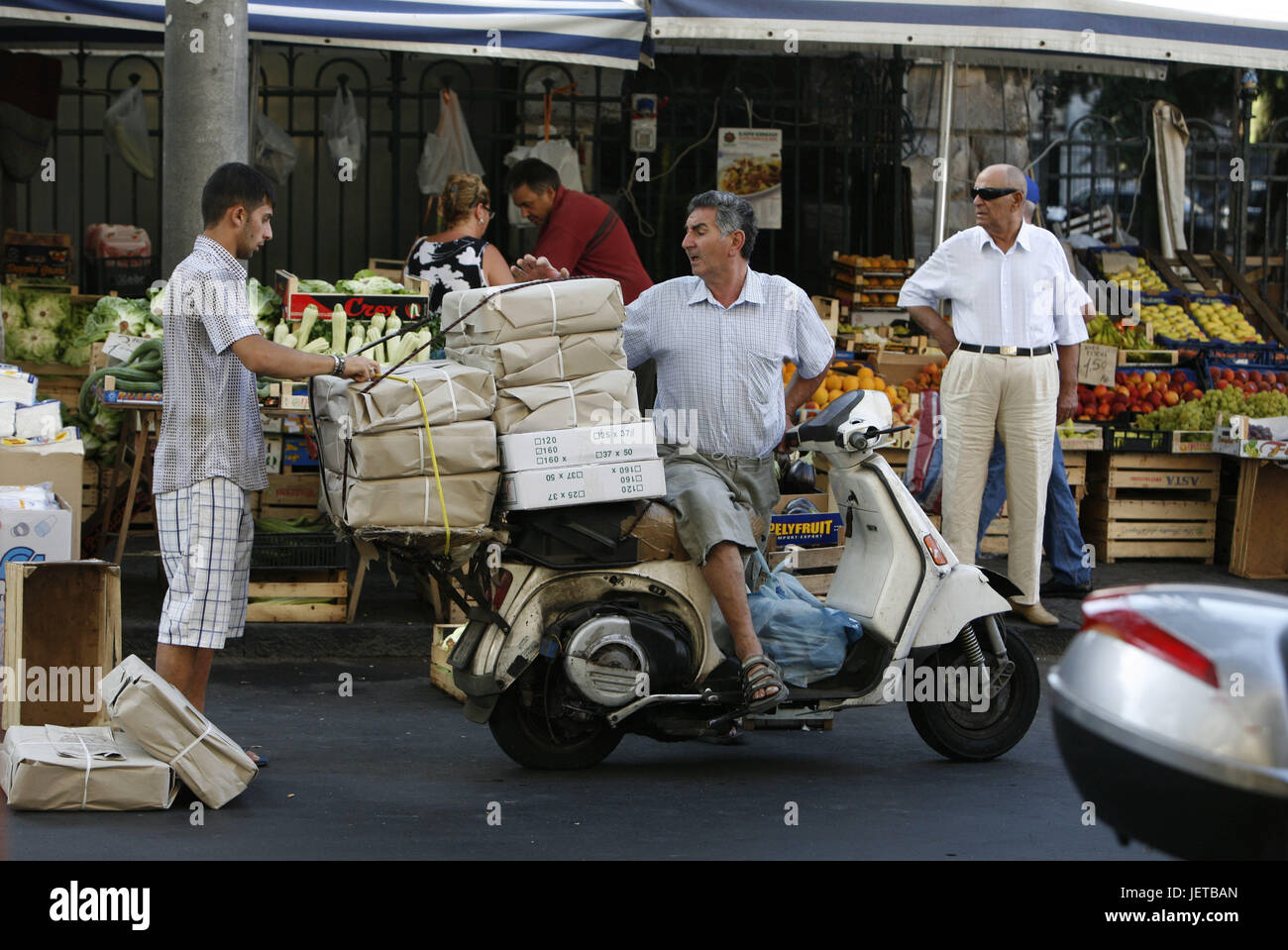 Italy, Sicily, Catania, Old Town, weekly market, street, motorbike driver, packages, advance, Southern Europe, lane, market, vegetable market, market stalls, sales, vegetables, fruit, choice, huge number, food, economy, retail trade, person, dealer, seller, motorbike driver, Stock Photo