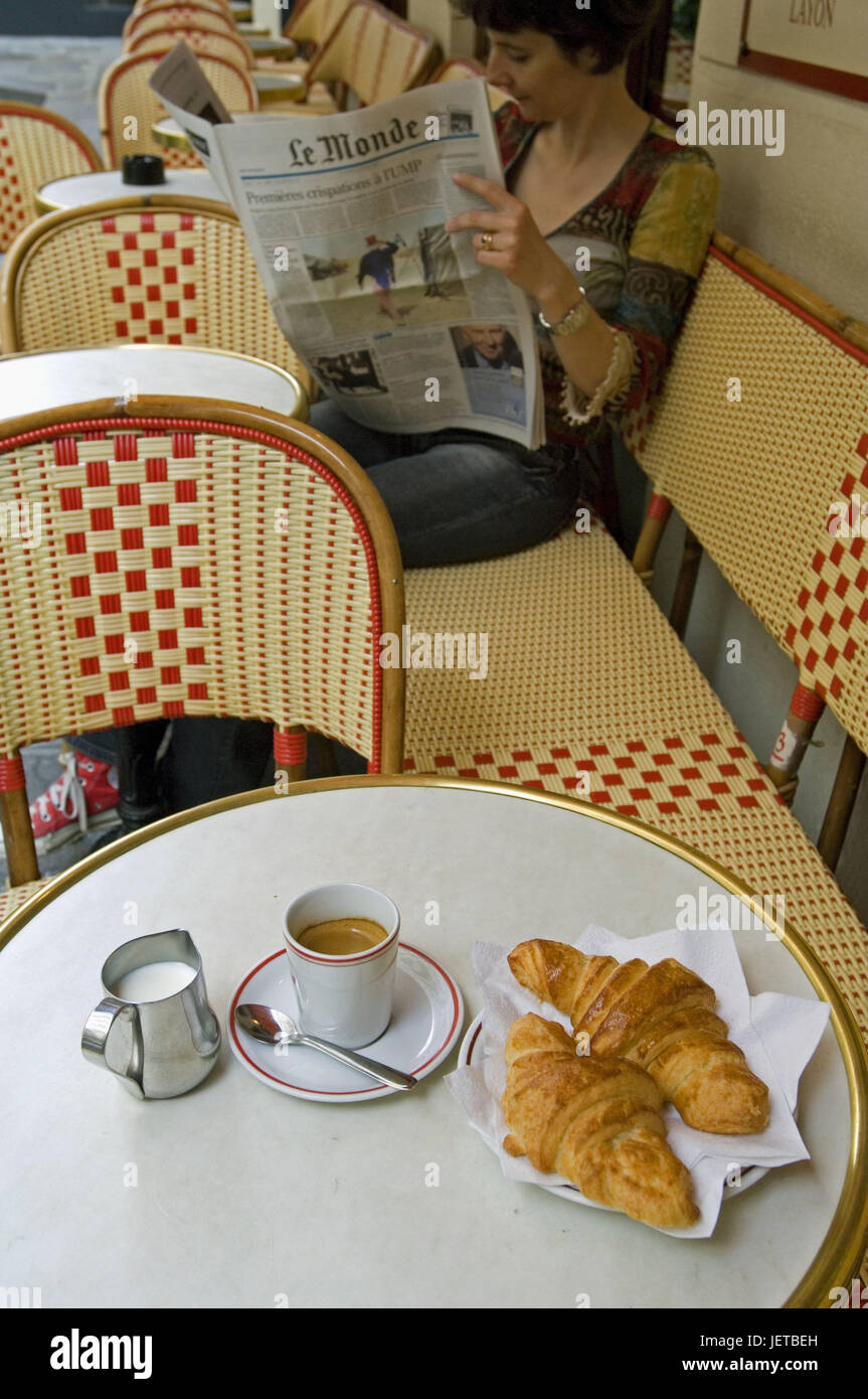 France, Paris, Saint-Germain of the Pres, cafe 'meadow of Chai de l'Abbaye', woman, newspaper reading, table, coffee, croissants, no model release, Stock Photo
