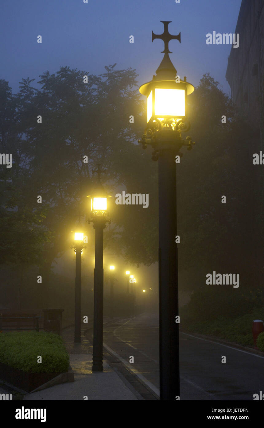 Spain, Catalonia, cloister of Montserrat, street lamps in the fog, Stock Photo