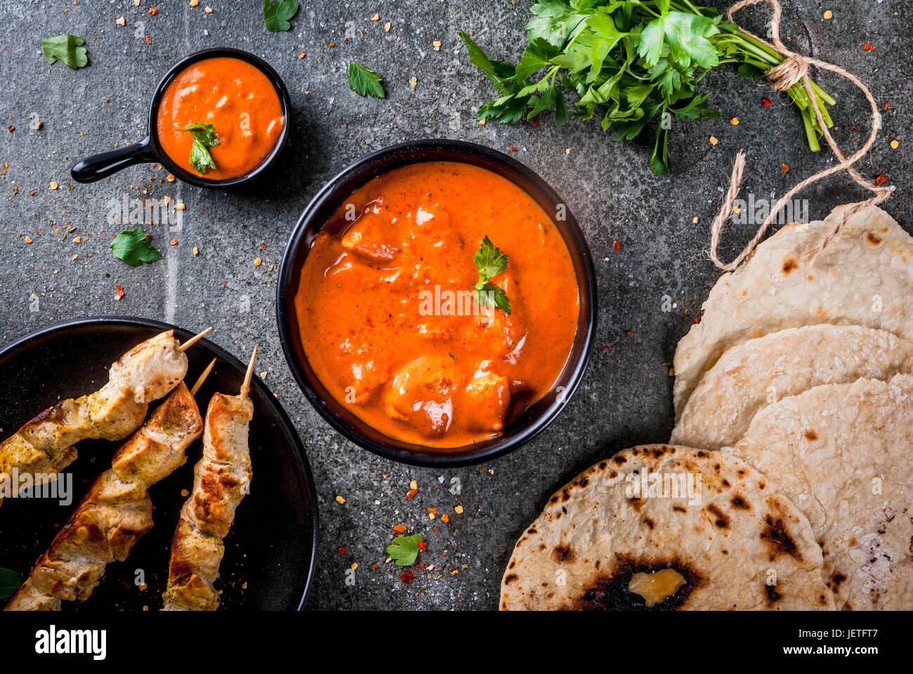 Indian food. Traditional dish spicy chicken tikka masala, butter chicken curry, with indian naan butter bread, spices, herbs. Served in bowl. sauce, o Stock Photo