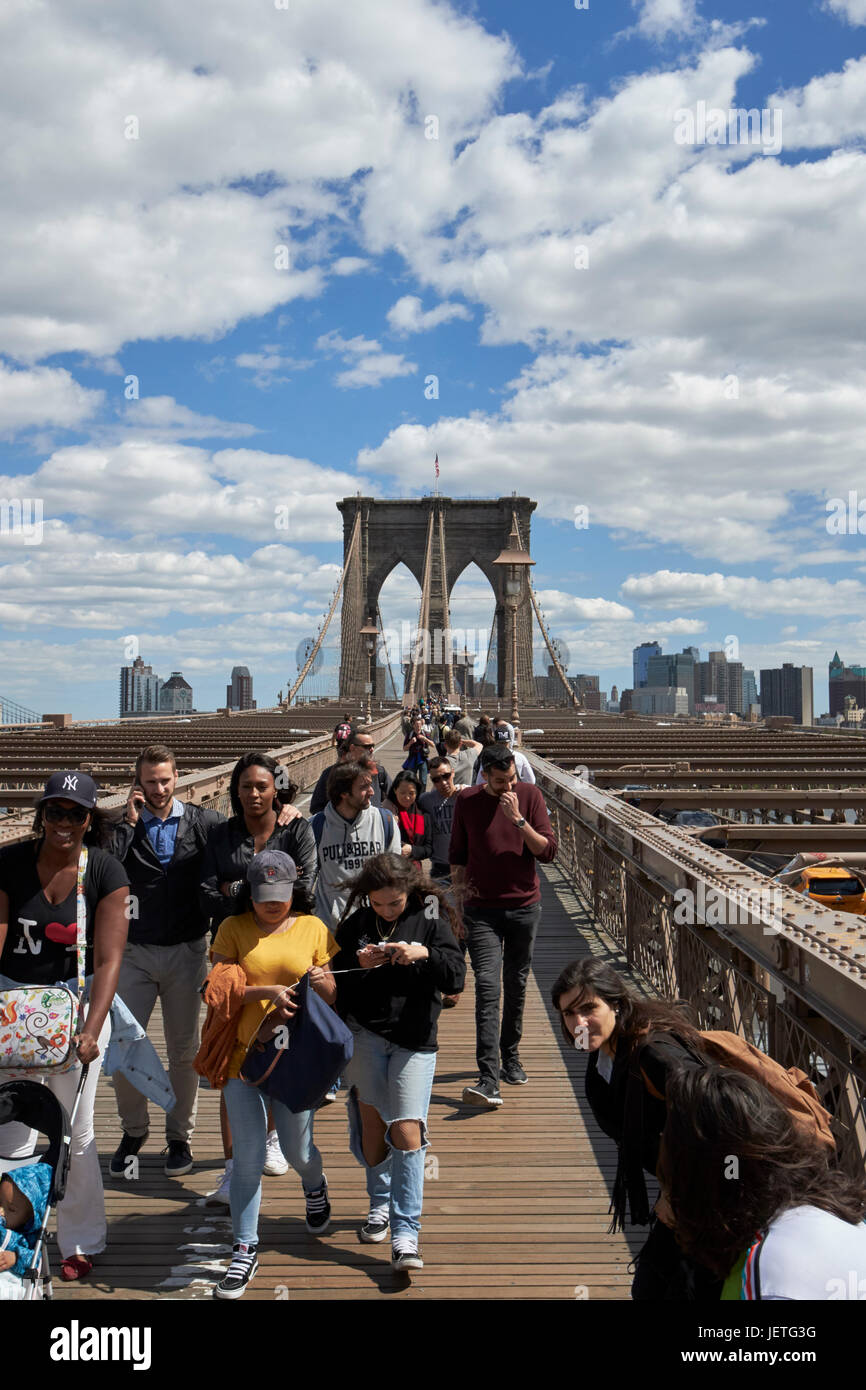 people walking over the brooklyn bridge New York City USA Stock Photo