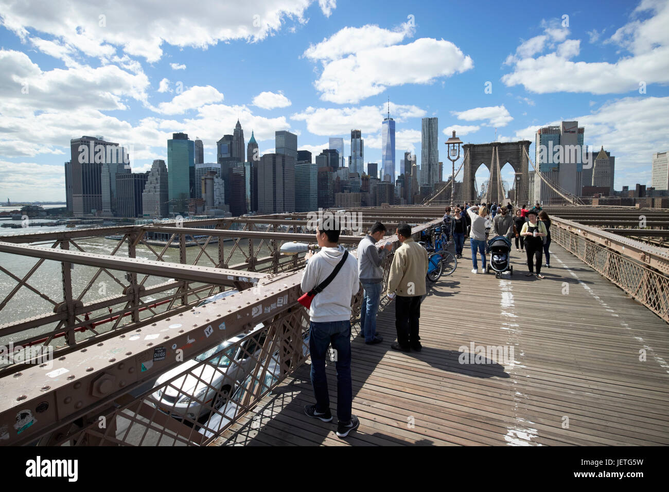 walking over the brooklyn bridge towards manhattan skyline New York City USA Stock Photo