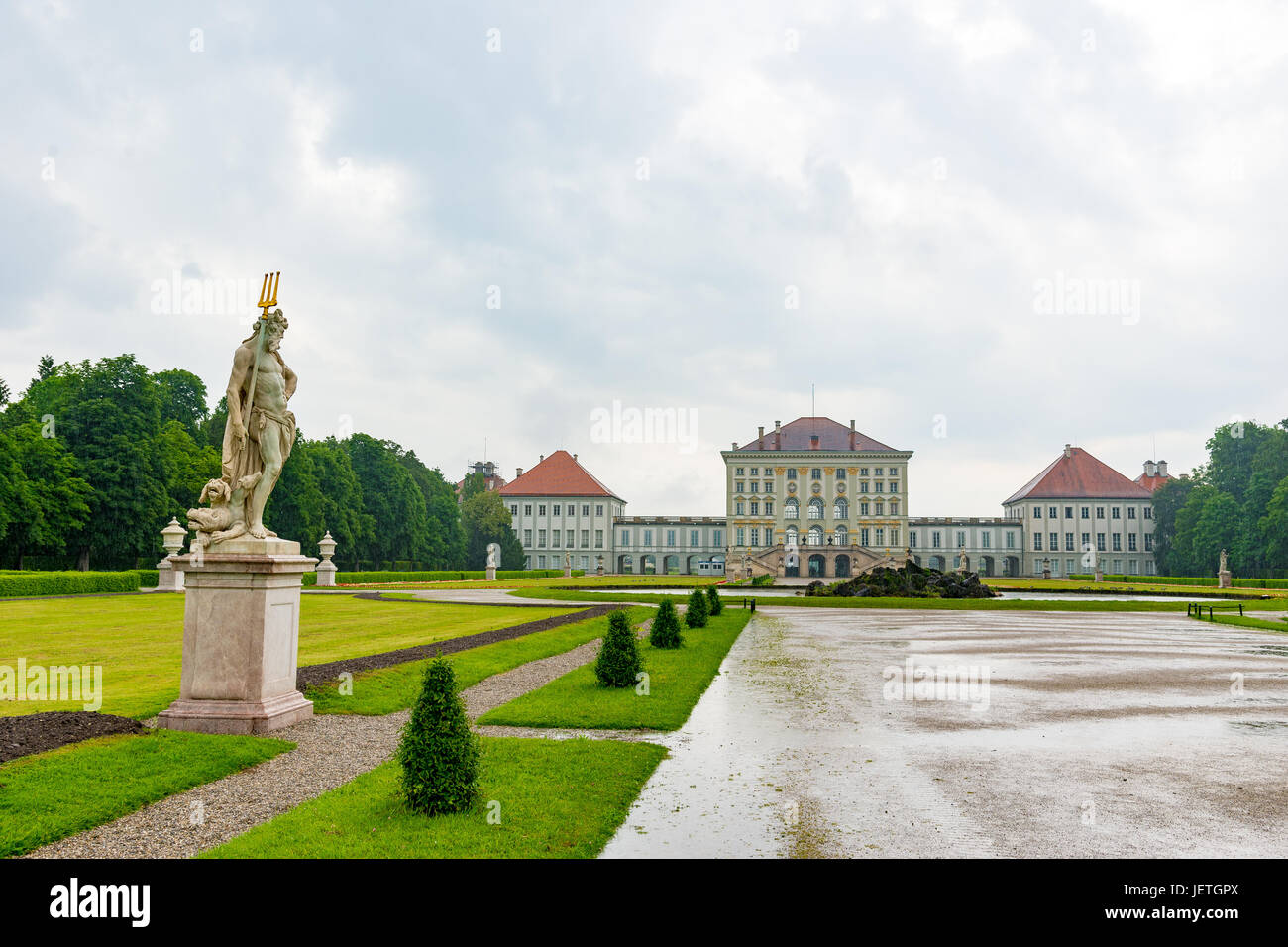 Munich, Germany - June 8. 2016: Statue Pluto by Dominik Auliczek. And the rear view of the Nymphenburg Palace. Munich, Bavaria, Germany Stock Photo