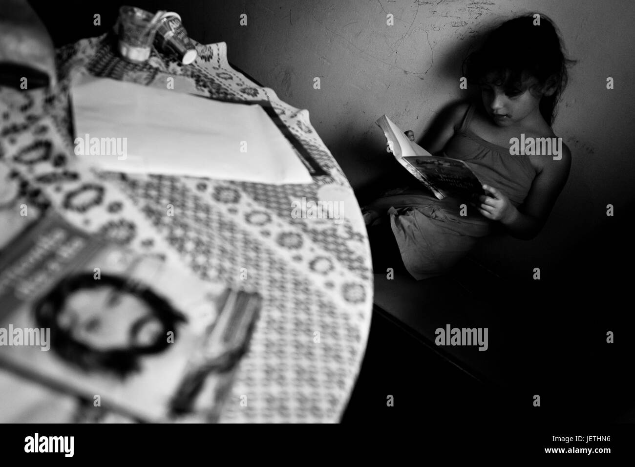 A Colombian girl reads a book in the corner during the religious ritual ...