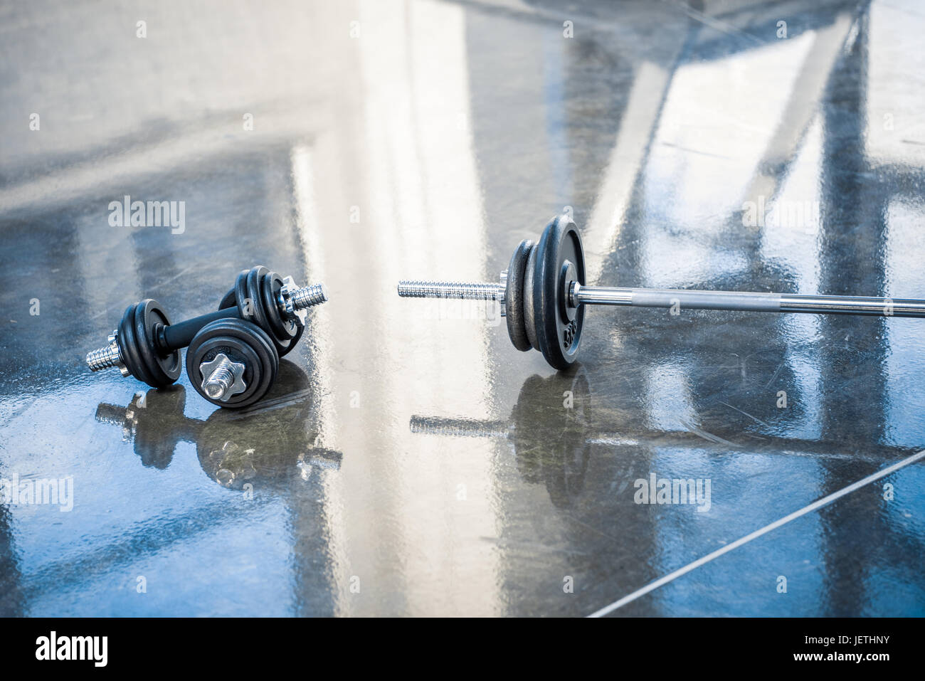 barbell and dumbbells on floor of exercise room Stock Photo Alamy