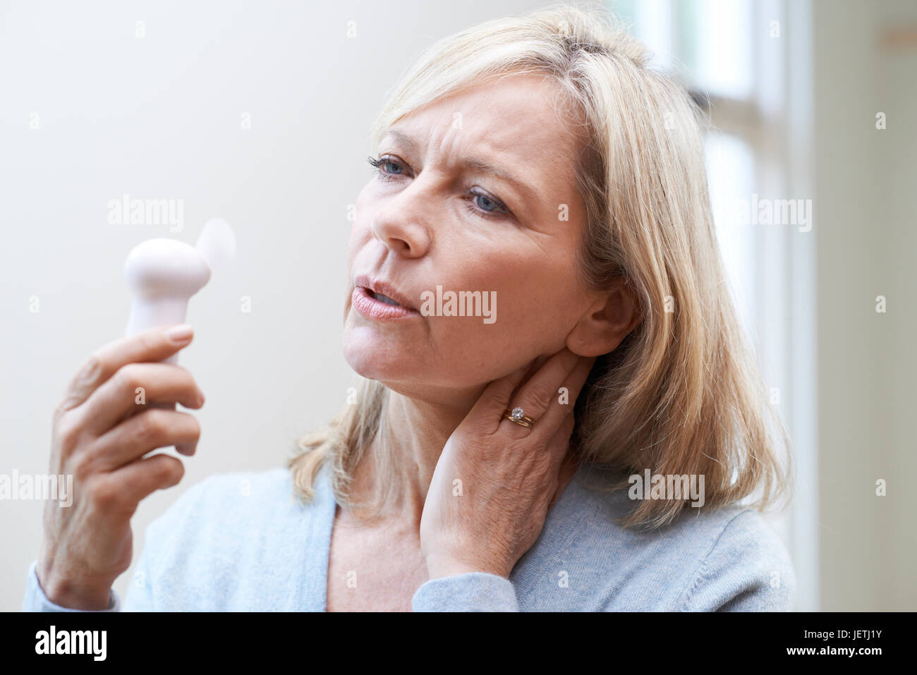 Mature Woman Experiencing Hot Flush From Menopause Stock Photo