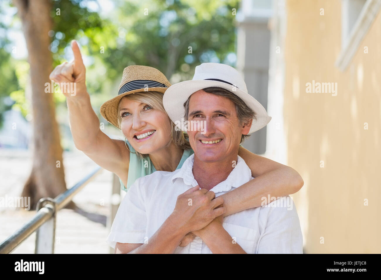 Man pointing woman hugging hi-res stock photography and images - Alamy