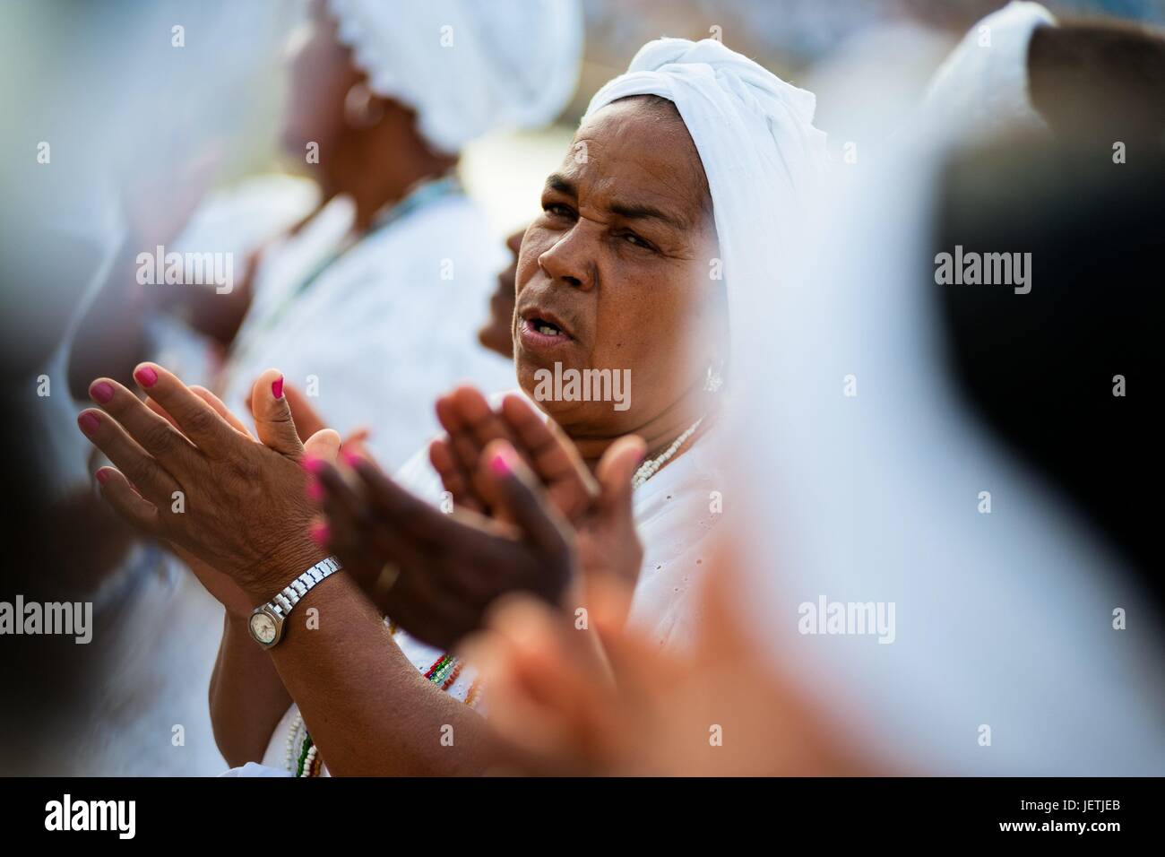 Baiana women sing and clap hands during the festival in honor to Yemanya, the goddess of the sea, in Salvador, Bahia, Brazil, 2 February 2012. Yemanya, originally from the ancient Yoruba mythology, is one of the most popular ‚Orixas, the deities from the | usage worldwide Stock Photo
