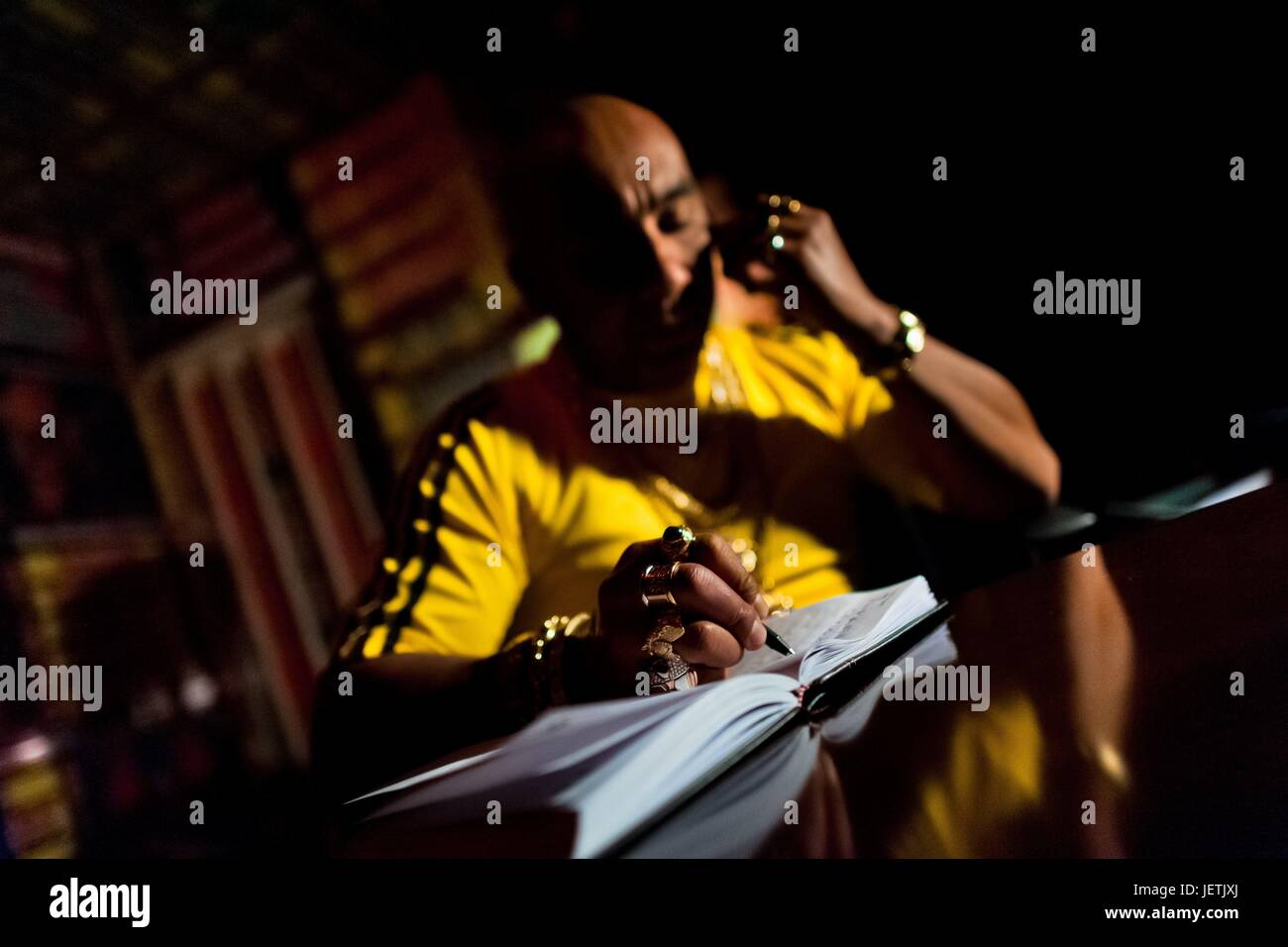 Ramiro Lopez, a Colombian ‚Äòbrujo‚Äô calling himself Shaman Llanero, provides spiritual consultation over the phone in his office in Bogota, Colombia, 29 June 2013. During the last decade, the religious globalization of the urban areas in Latin Am | usage worldwide Stock Photo
