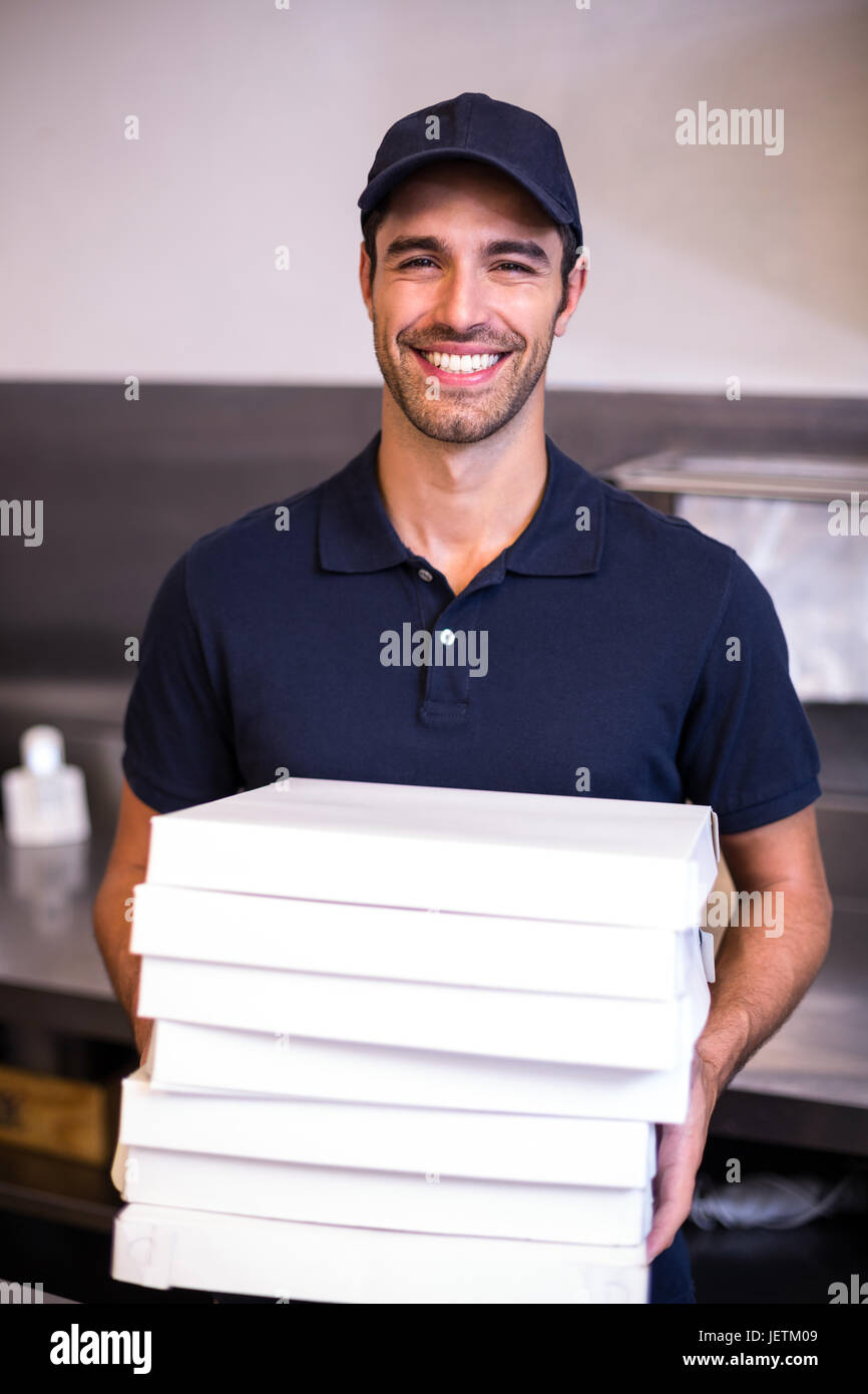 Pizza delivery man carrying boxes Stock Photo Alamy