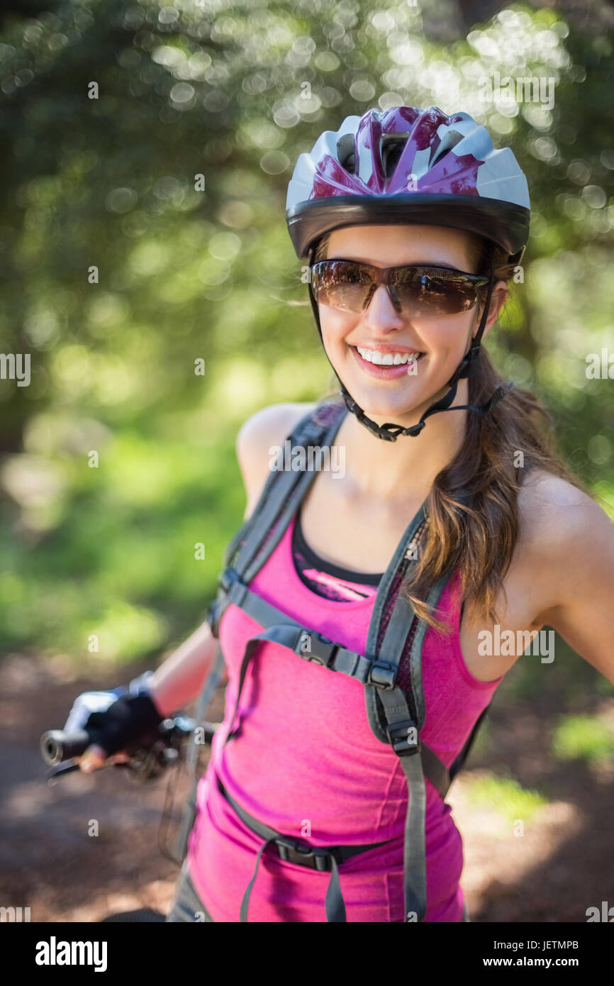 Portrait of smiling woman at forest Stock Photo - Alamy
