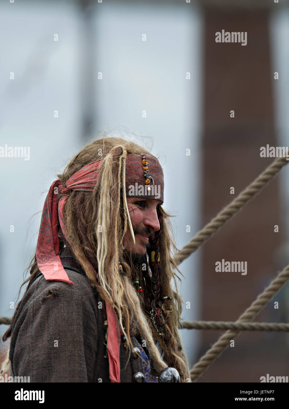 A man dressed as a pirate to welcome people aboard a tall ship at the Mersey Water Festival in Liverpool UK Stock Photo