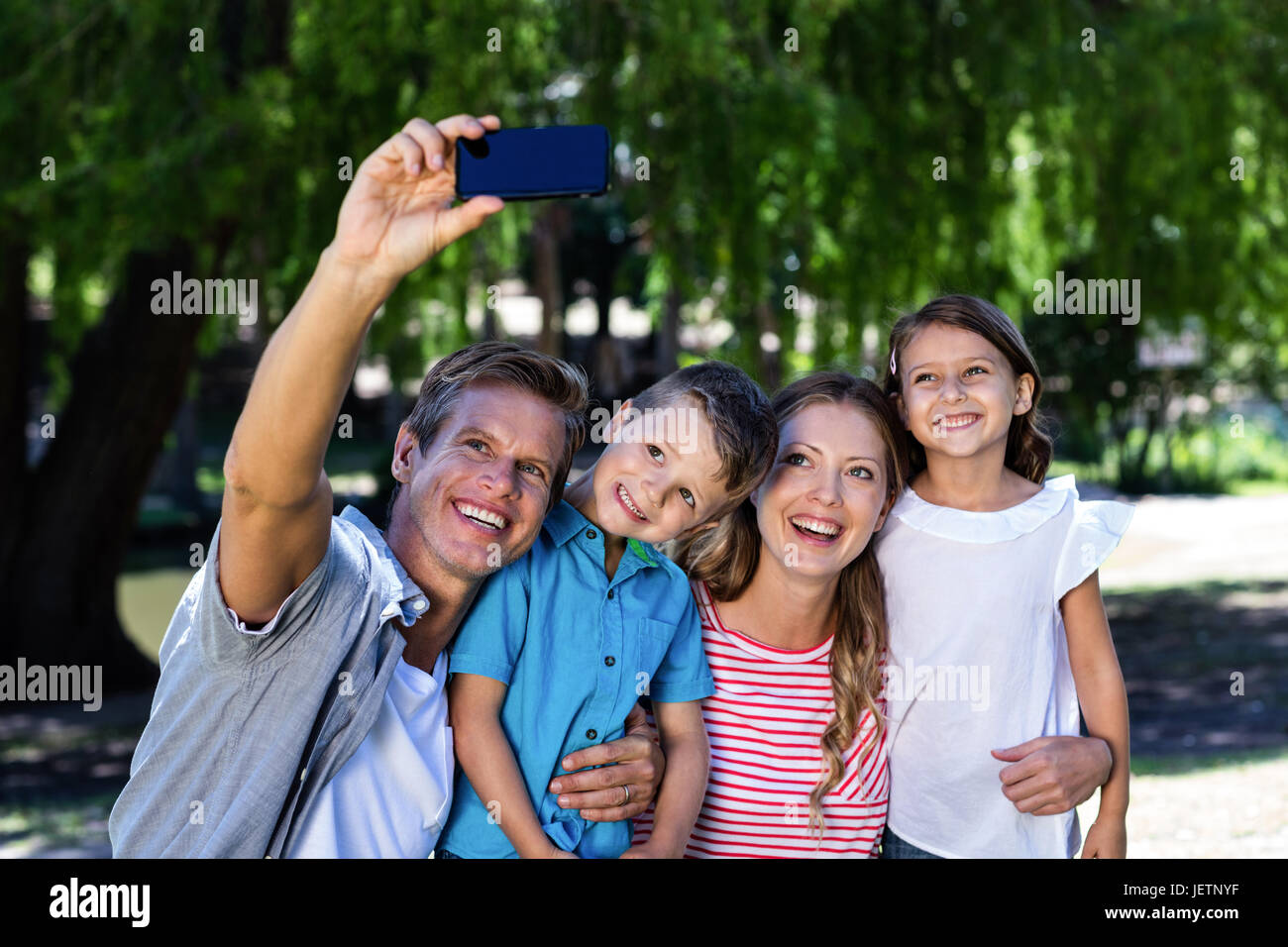 Happy family taking a selfie in the park Stock Photo - Alamy