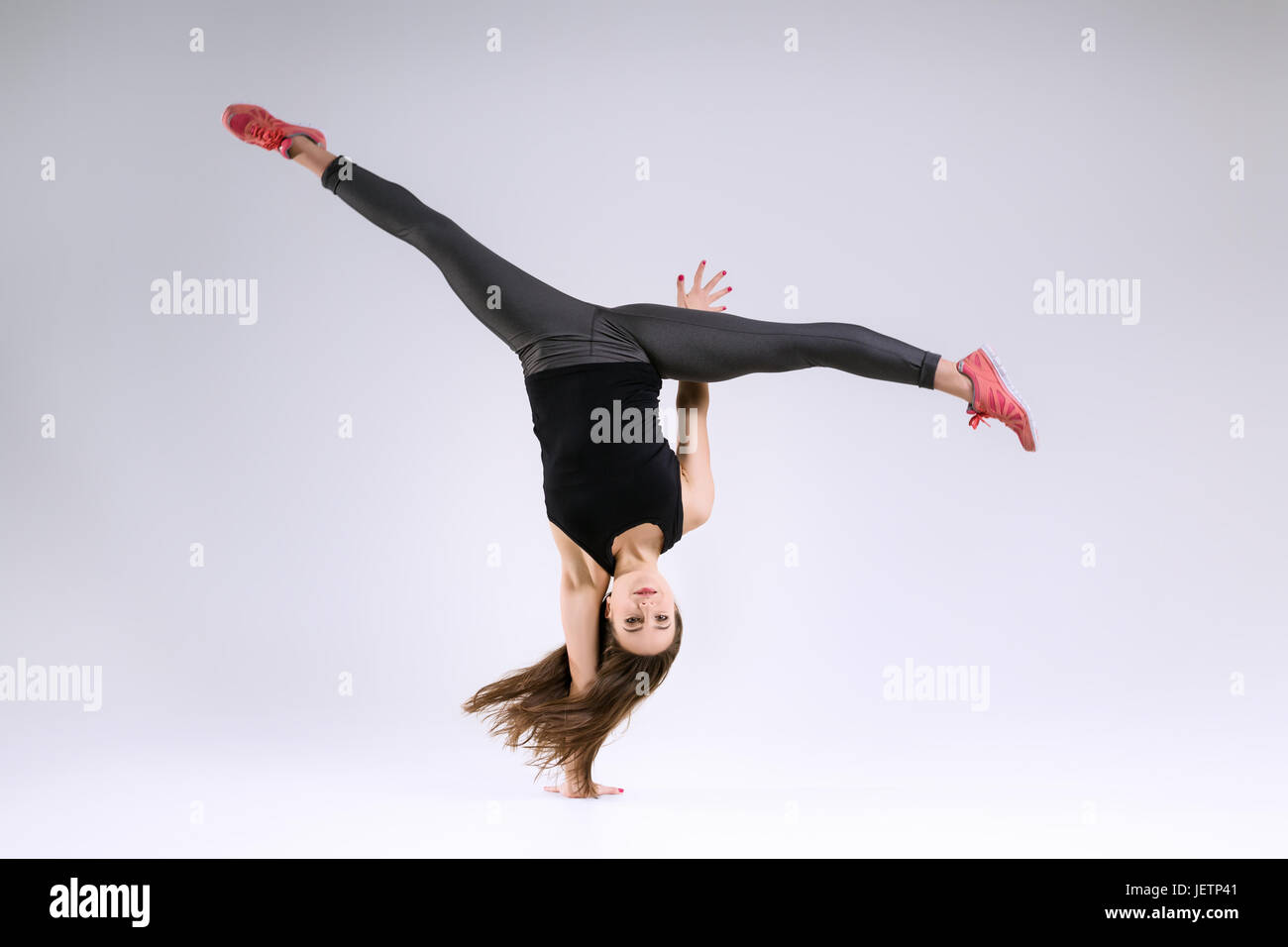 Girl in jump on a gray background Stock Photo