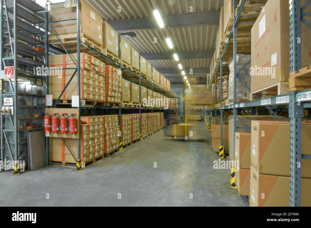 Automatic warehouse with forklift in Bewegungsunsch?rfe, Hochregallager mit Gabelstapler in Bewegungsunschaerfe Stock Photo