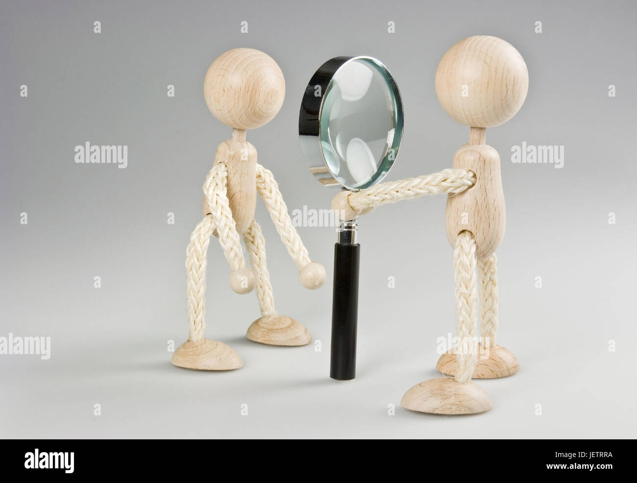 Two wooden figures with magnifying glass, Zwei Holzfiguren mit Lupe Stock Photo