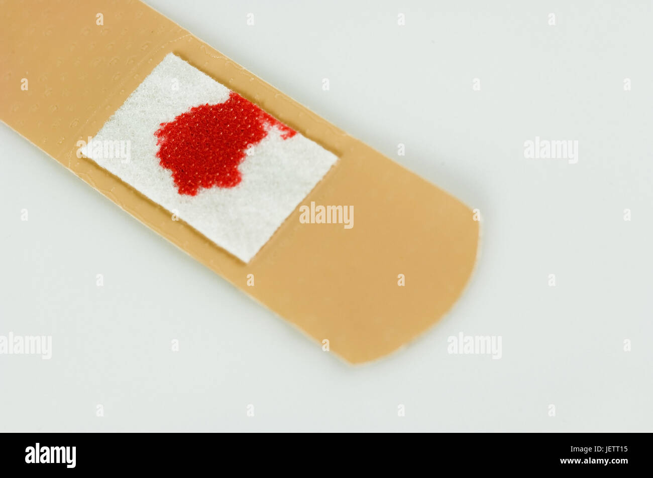 Used sticking plaster with bloodstain, Gebrauchtes Heftpflaster mit Blutfleck Stock Photo