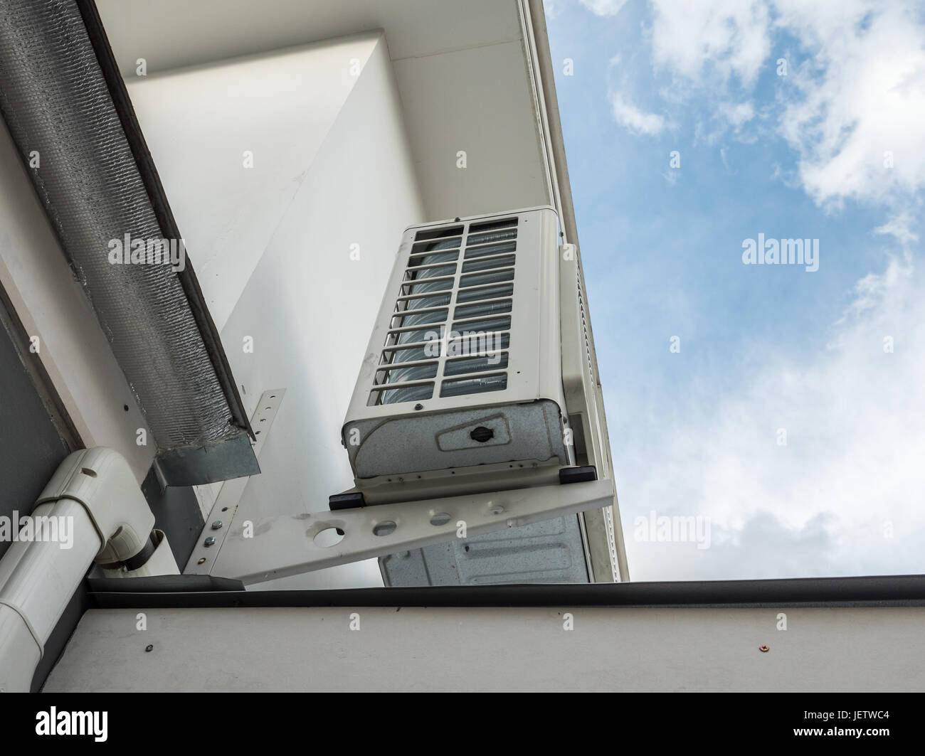 Large air compressor unit on the roof of the modern house under the