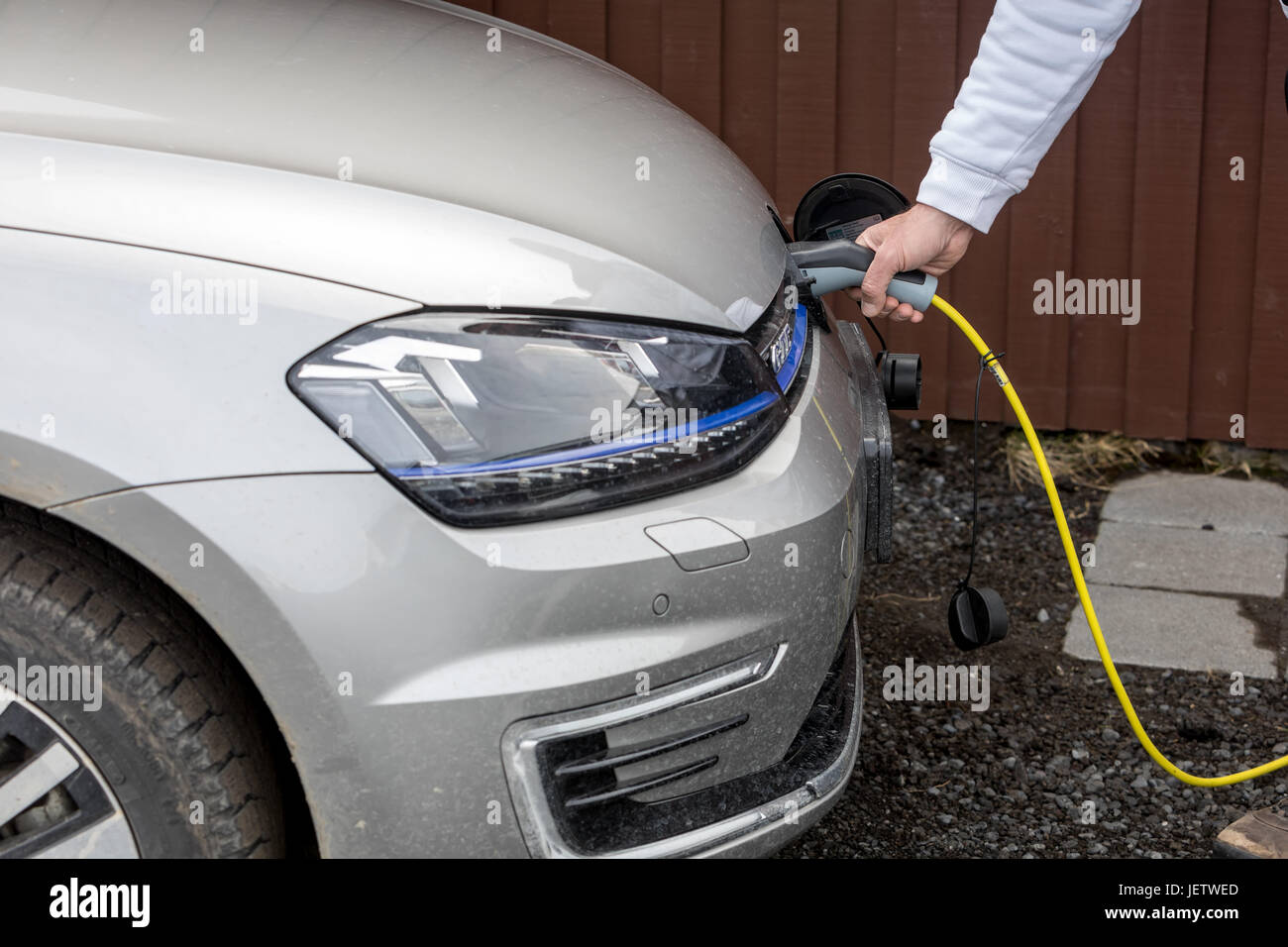 Vik, Iceland - Marsh 29, 2017: Charging An Electric Car With The Power Cable Supply Plugged In Stock Photo