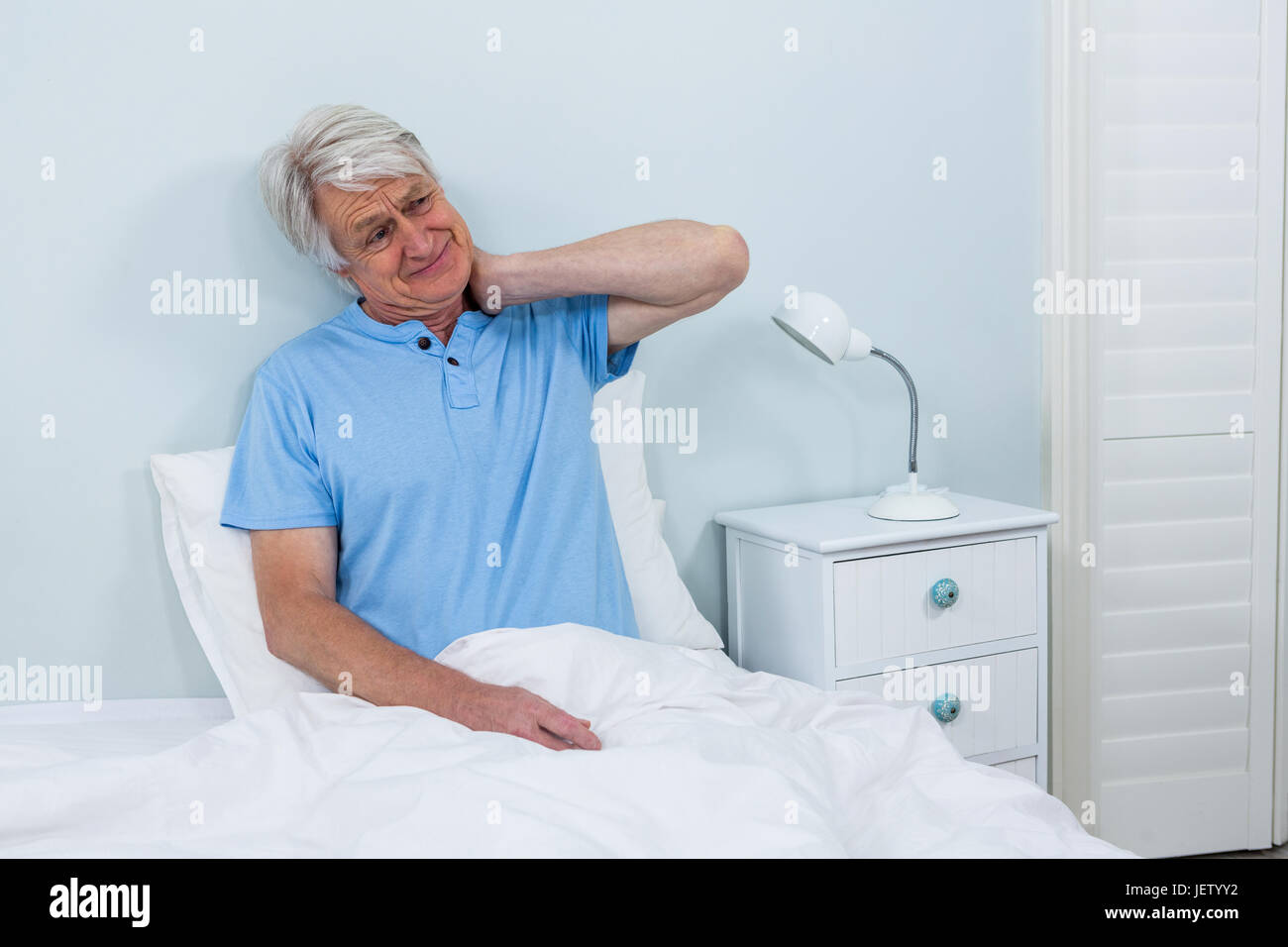 Senior man suffering from neck pain Stock Photo - Alamy