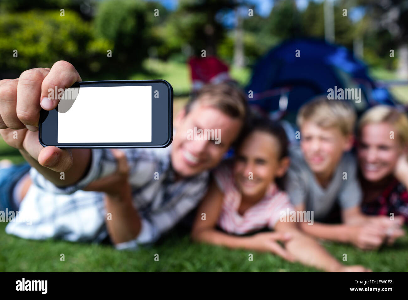 Happy family taking a selfie in the park Stock Photo - Alamy