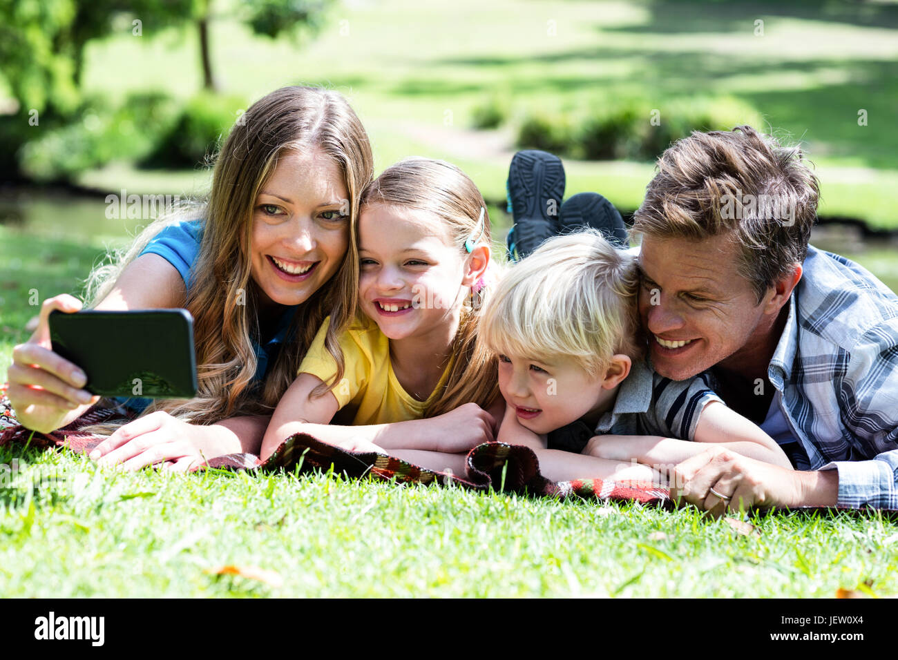 Happy family taking a selfie in the park Stock Photo - Alamy