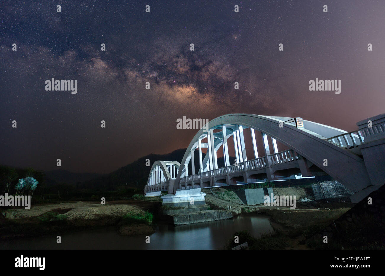 Beautiful Night Starry sky with Rising Milky Way over the bridge, Thailand Stock Photo